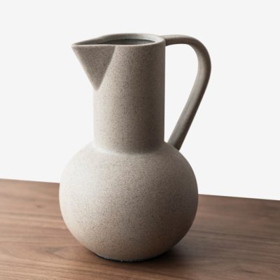 black-textured-ceramic-jug-vase-wooden-table.jpg